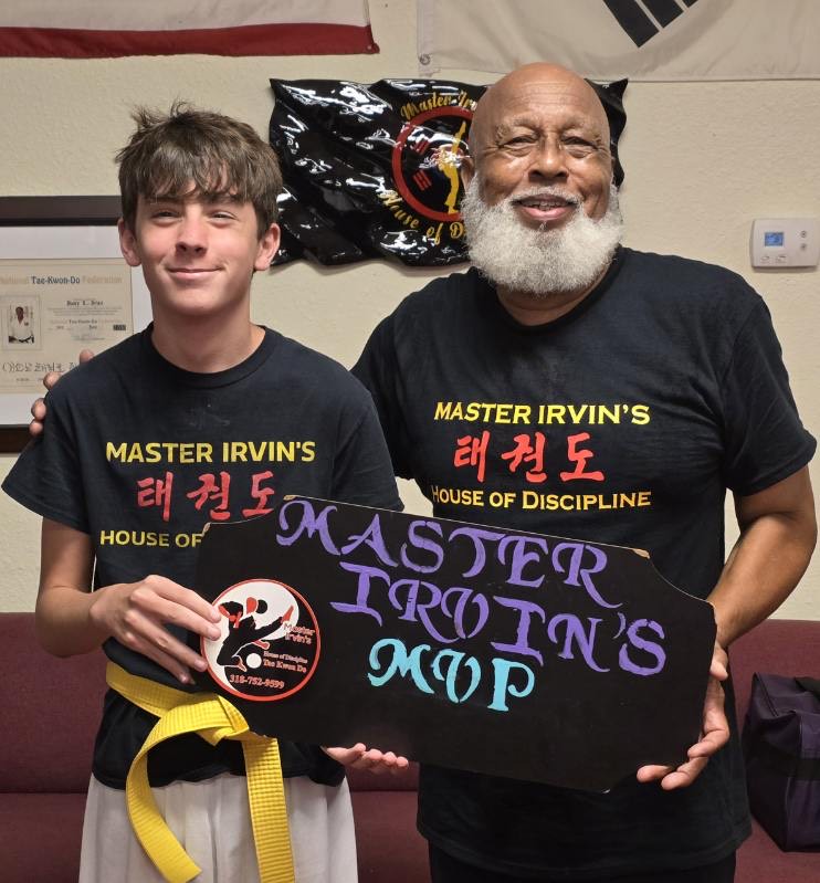 Master Irvin presenting an award to a student.