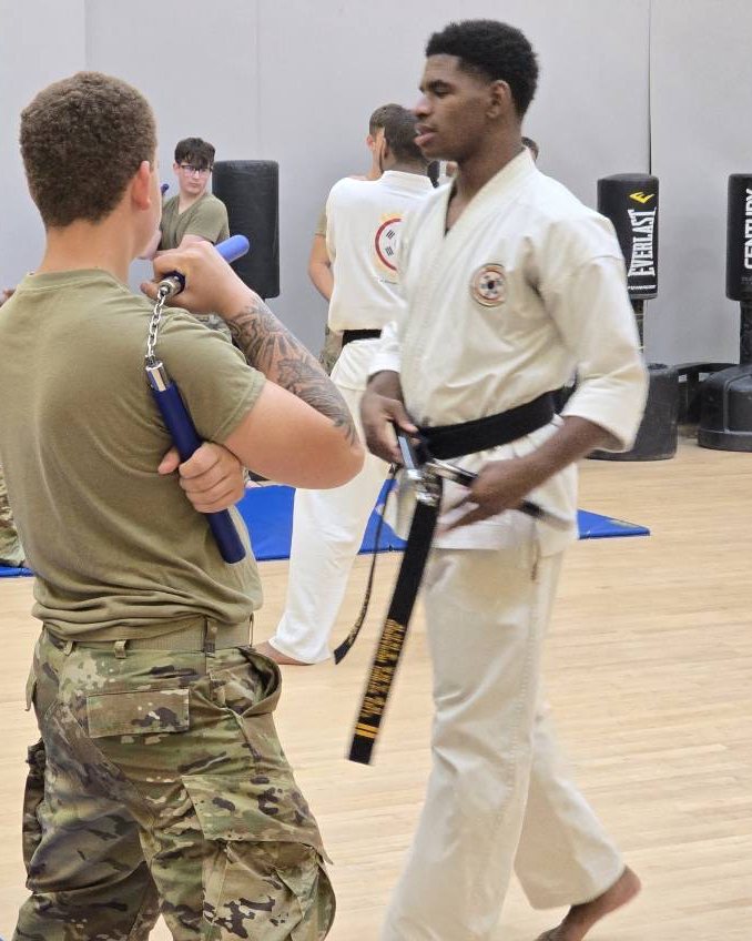 Students training with nunchaku during a weapons session.