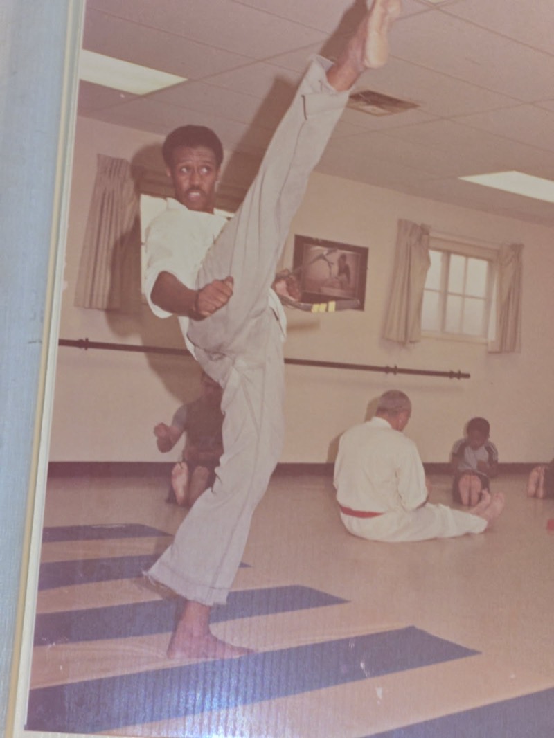 Master Irvin throwing a high kick in his dobok during a class in the 1970s.