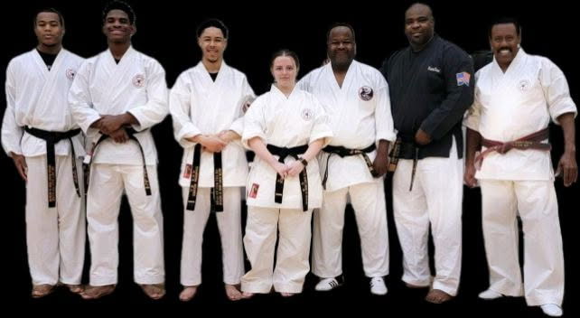Black belt instructors standing in a line.