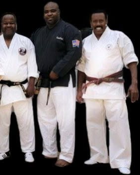 Master Irvin standing with two of his black belt instructors.