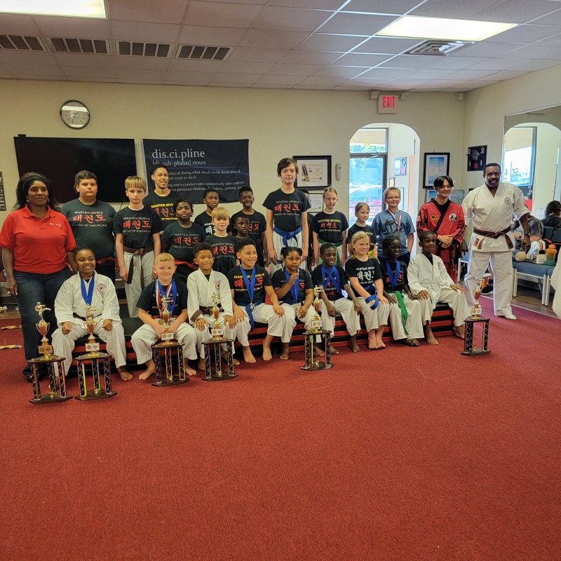 A group of students and instructors gathered on promotion day.